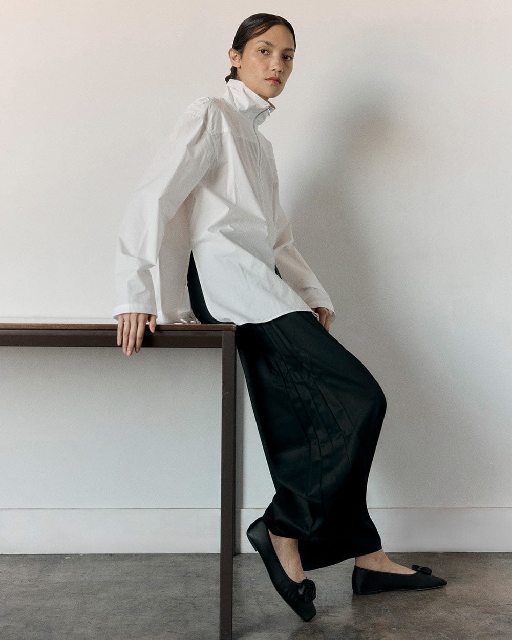 Model leaning on table