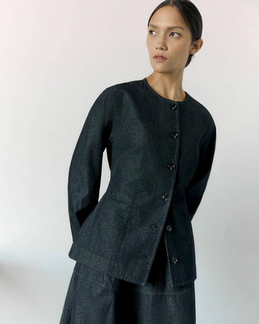 Model wearing dark outfit